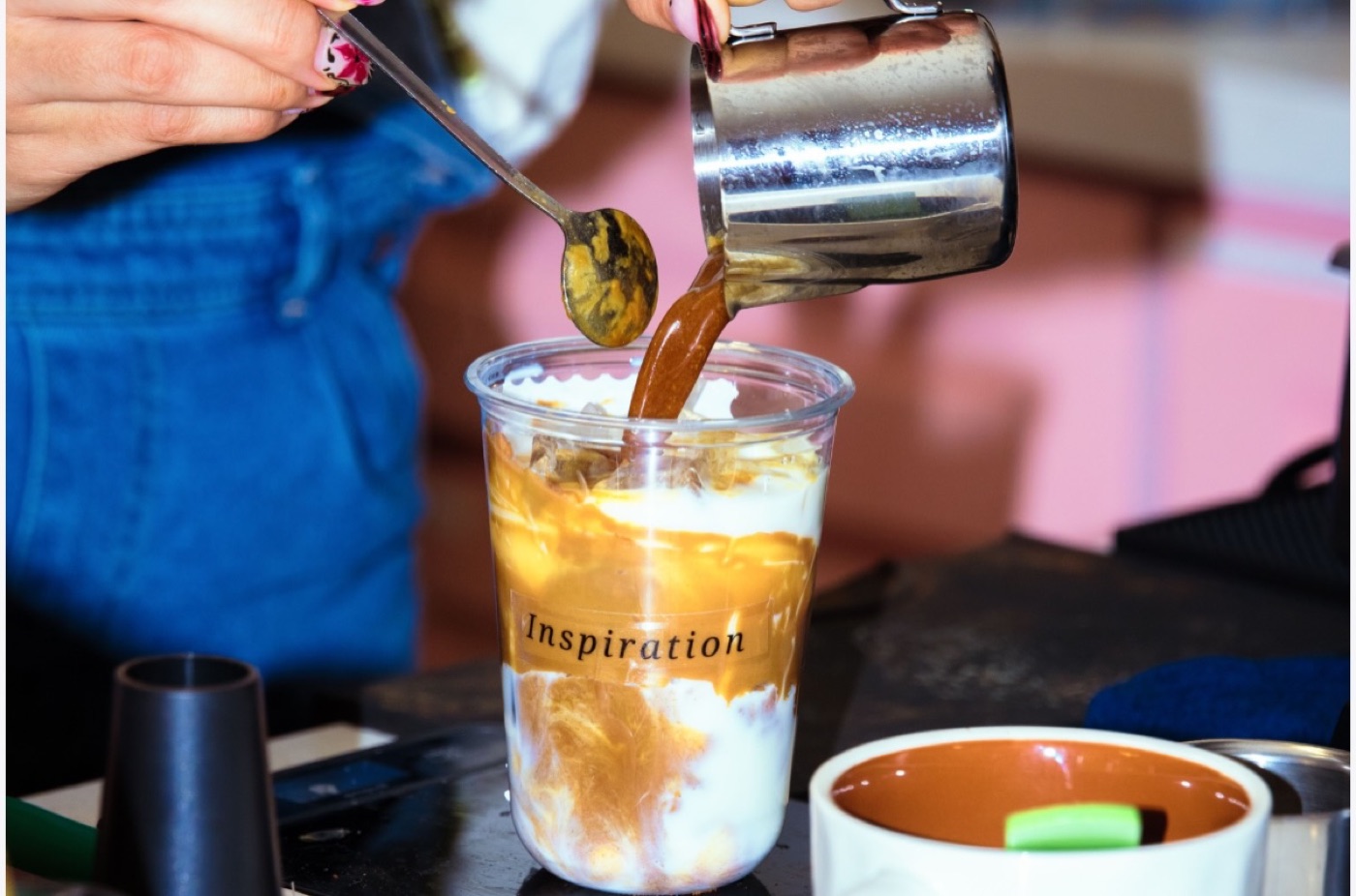 Espresso poured over an iced latte