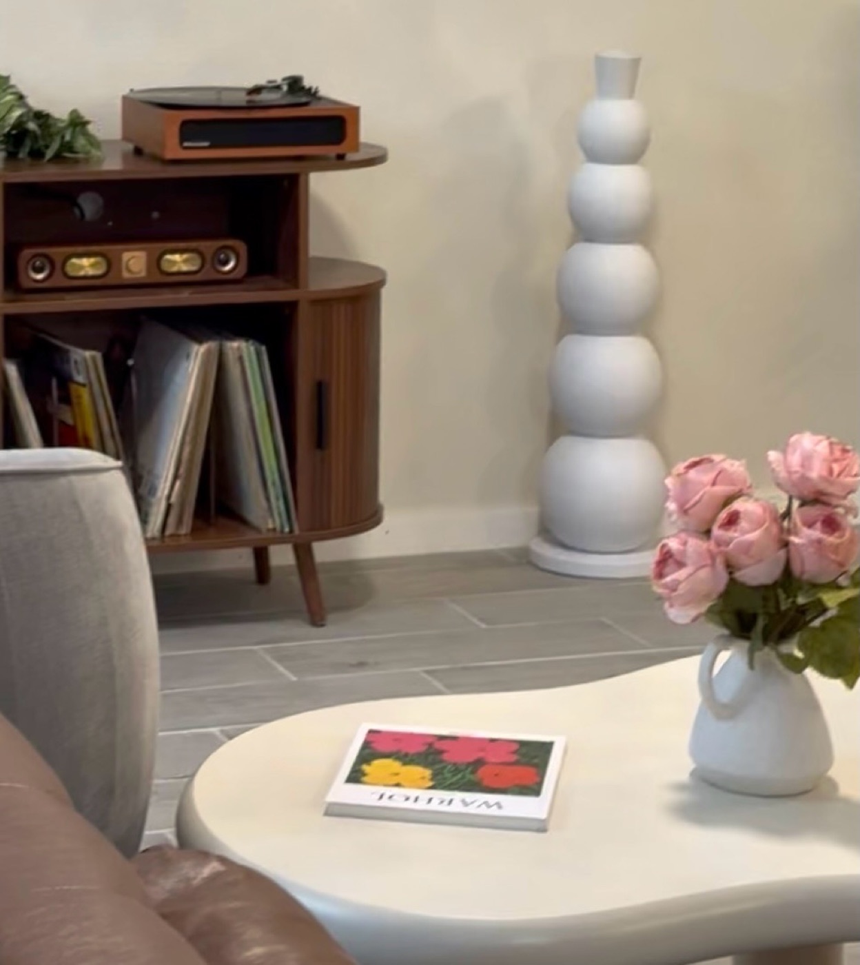 A corner of the café with a record player and pink roses