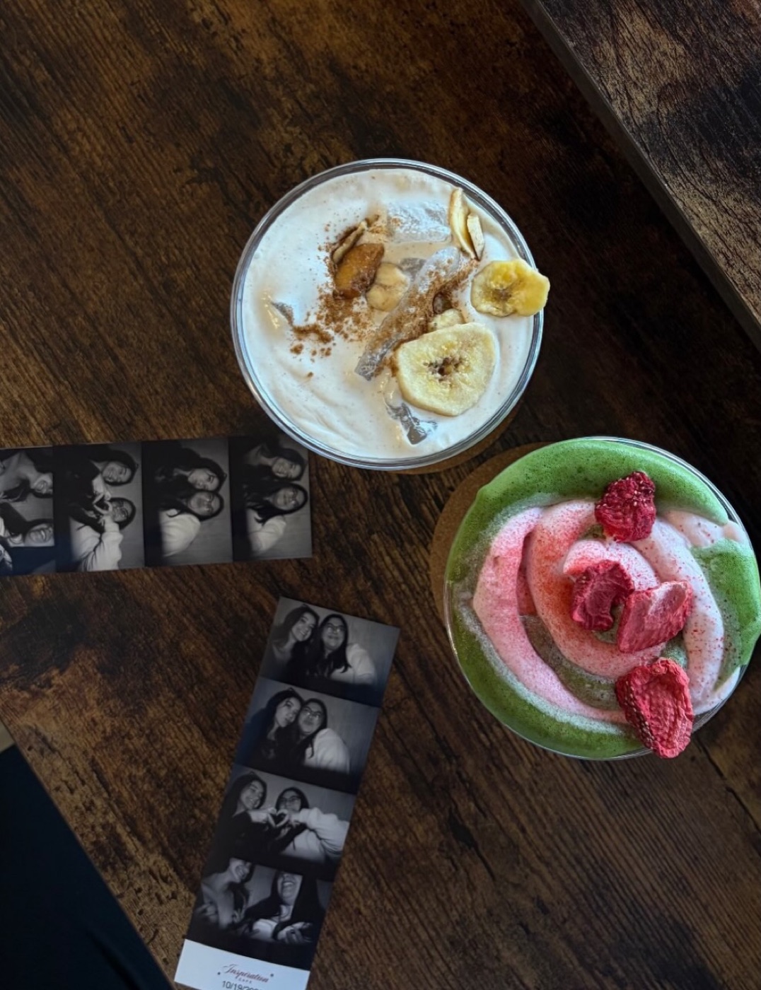 Photobooth strips beside a latte and a strawberry drink